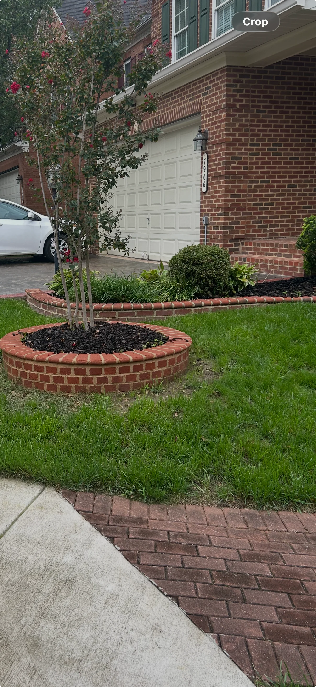 Professional hardscape crew with tools and materials on a residential job site, showcasing pavers, stone, and concrete installation work.