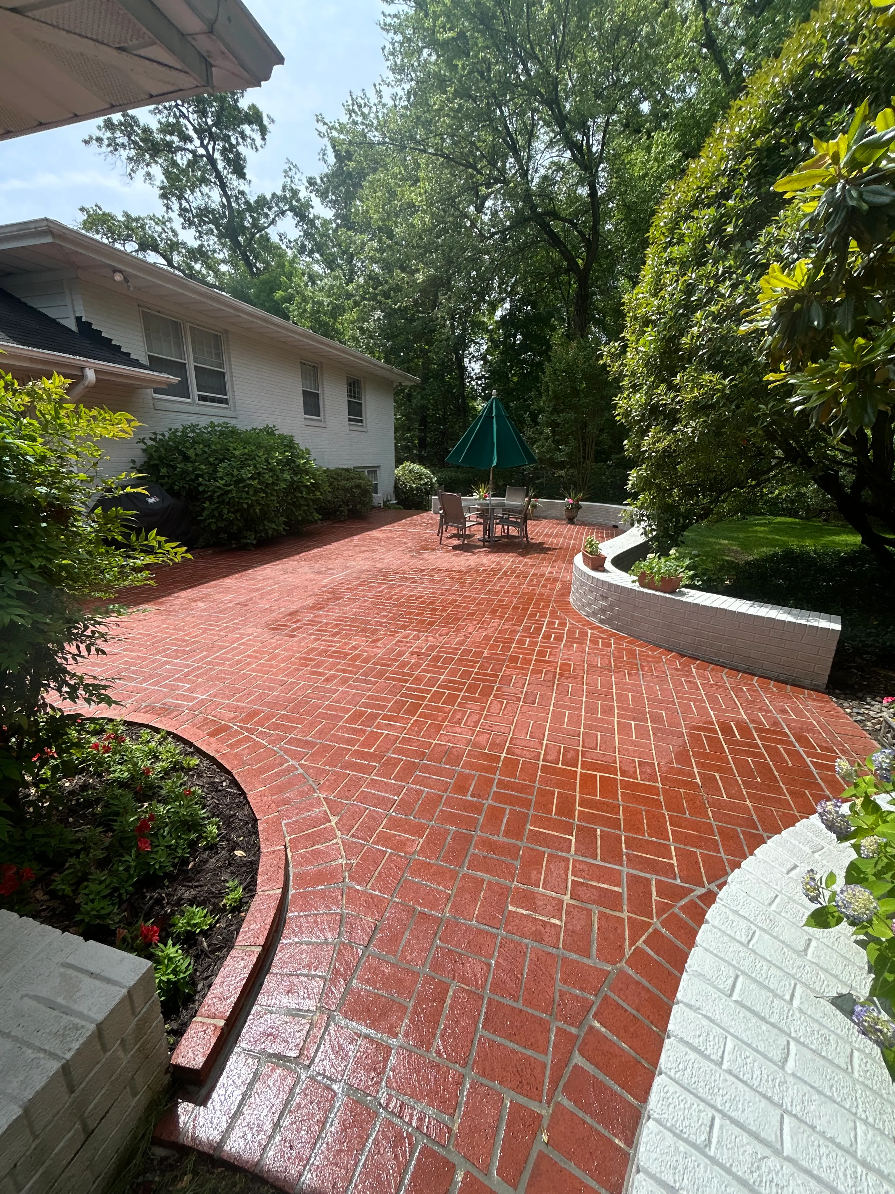 Red brick patio with curved retaining wall and outdoor seating area