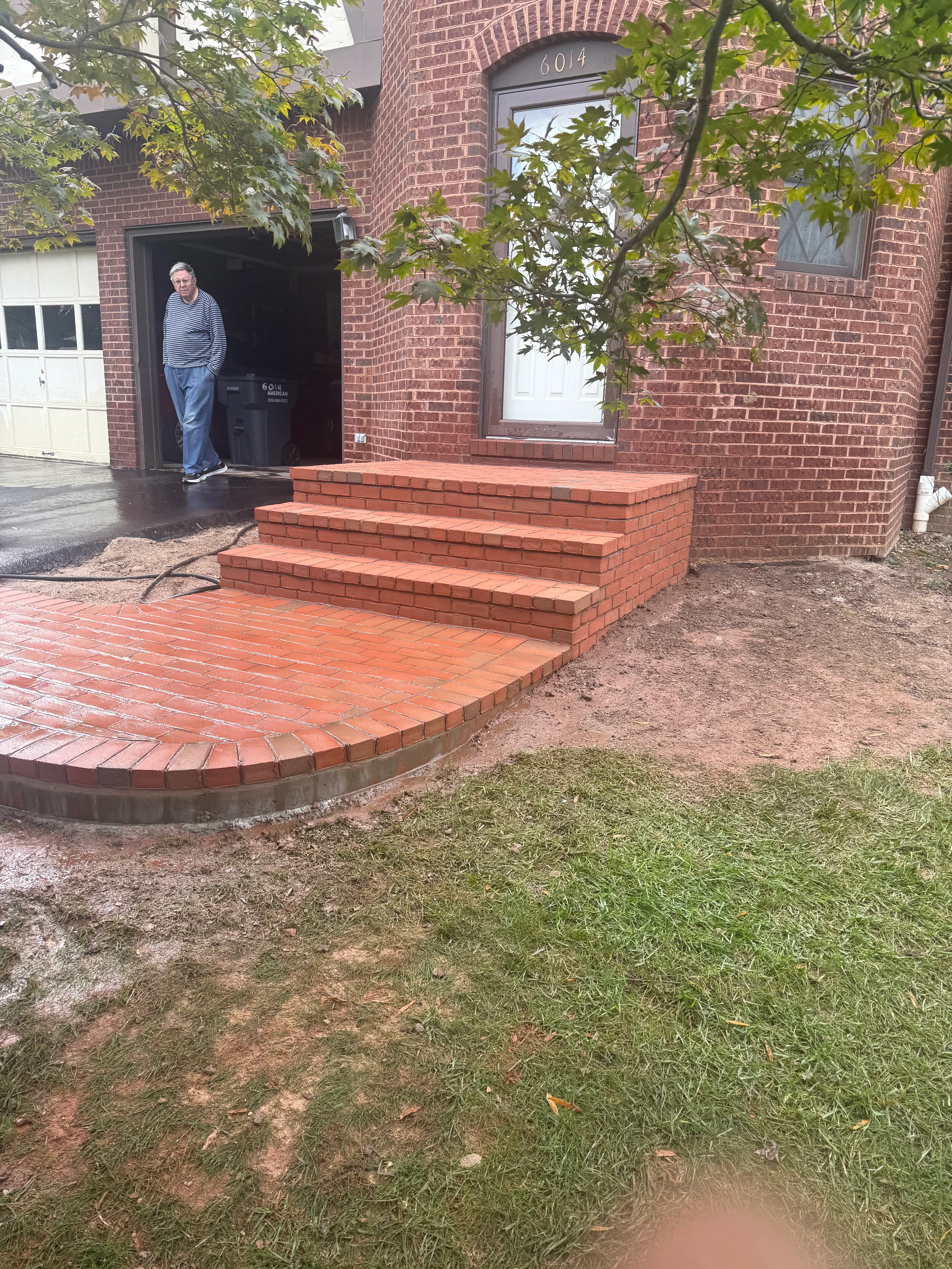 Brick entry steps and curved patio at residential home in Fairfax